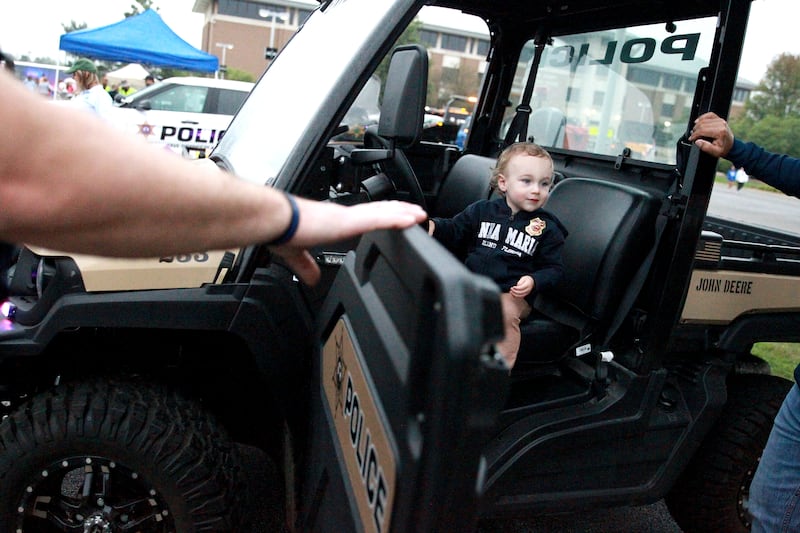 Wyatt Bolin, 2, of Geneva sits in a Kane County Sheriff utility vehicle duirng the Kane County Sheriff’s National Night Out in St. Charles on Tuesday, Aug. 6, 2024.