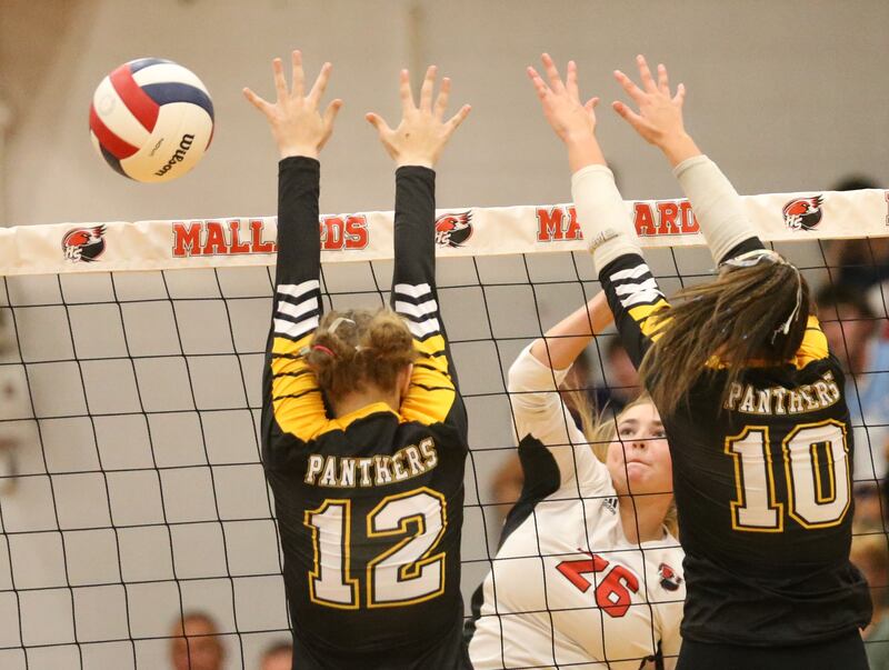 Henry-Senachwine's Brooklynn Thompson sends the ball past Putnam County's Chloe Parcher and Myah Richardson on Thursday, Aug. 28, 2025 at Henry-Snachwine High School.