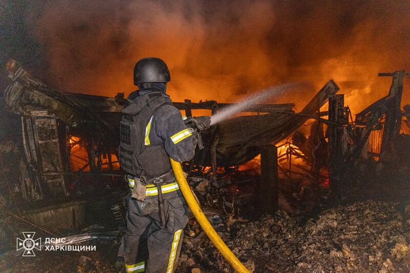 In this photo provided by the Ukrainian Emergency Service, firefighters tries to put out the fire following a Russian drones attack in Kharkiv, Ukraine, Wednesday, Sept. 24, 2025. (Ukrainian Emergency Service via AP)