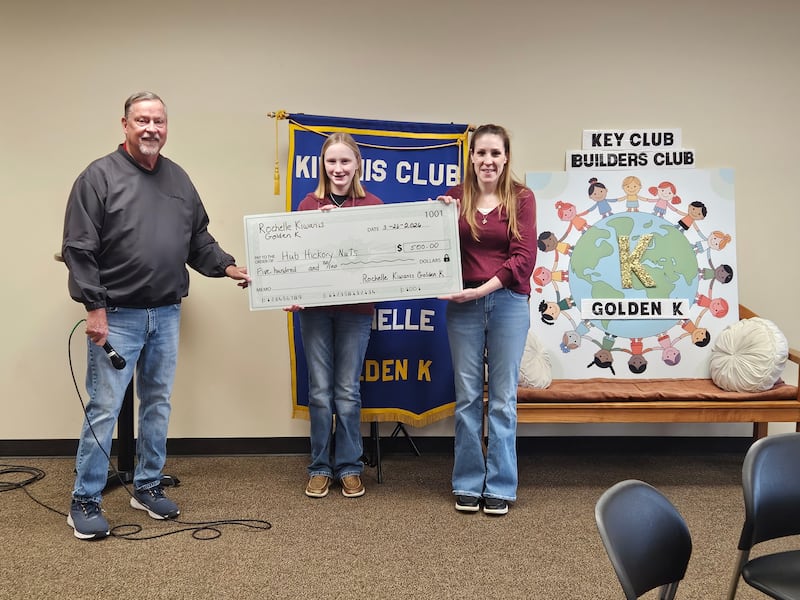 The Hub Hickory Nuts 4-H club recently received a donation from Kiwanis Golden K of Rochelle. Pictured is Shelby Harbaugh receiving the donation with her mother, Amanda Harbaugh.