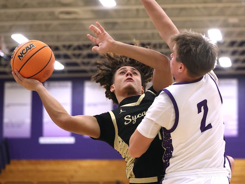 Sycamore's Josiah Mitchell goes to the basket against Rochelle's Van Gerber Friday, Dec. 5, 2025, during their game at Rochelle High School.
