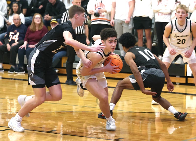 Sycamore's Marcus Johnson splits two Kaneland defenders during their game Friday, Jan. 9, 2025, at Sycamore High School.