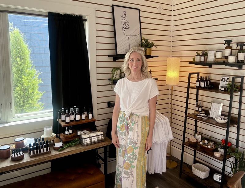 Sarah Coyle stands beside her handcrafted skincare and wellness products inside Amber + Smoke, her shop located in the Shoppes at Grandon Plaza at 310 Second Avenue in Sterling, Illinois.