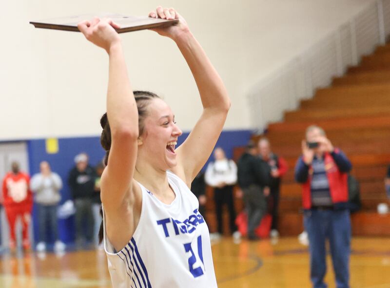 Princeton's Keighley Davis holds the plaque after defeating Illinois Valley Central in the Princeton High School Girls Basketball Holiday Tournament on Saturday, Nov. 22, 2025 at Princeton HIgh School. The Tigers won in double overtime.