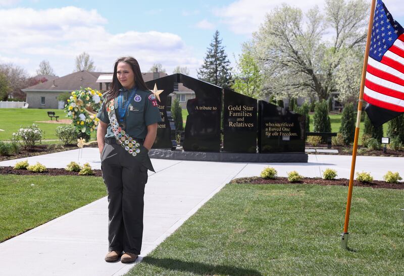 Alexis McCullough, 17, of Bourbonnais, stands in front of the new Gold Star Families Memorial Monument, which she successfully completed for her Eagle Scout project, during the dedication ceremony at Marcotte Park in Bourbonnais on Saturday, April 26, 2025.