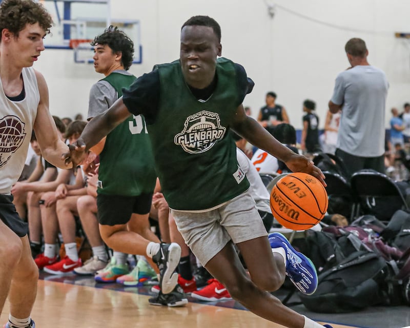Glenbard West's Josh Abushanab drives past the defense in their Riverside-Brookfield Shootout basketball game. June 20, 2025 in Riverside.