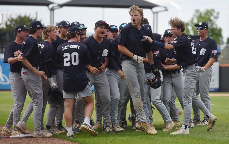 Cary-Grove’s Brock Iverson, middle, celebrates his two-run, fourth-inning home run with his teammates during the Class 3A supersectional baseball game against St. Patrick at Wintrust Field on Monday, June 9, 2025 in Schaumburg.