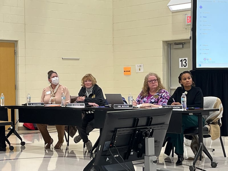 Joliet Public Schools District 86 Inspectors Sandra Aguirre (left), and Deborah Ziech, along with Superintendent Theresa Rouse and Deputy Superintendet Tanisha Cannon, listen to speakers on Thursday, Jan. 8, 2026, at Isaac Singleton Elementary School in Joliet.