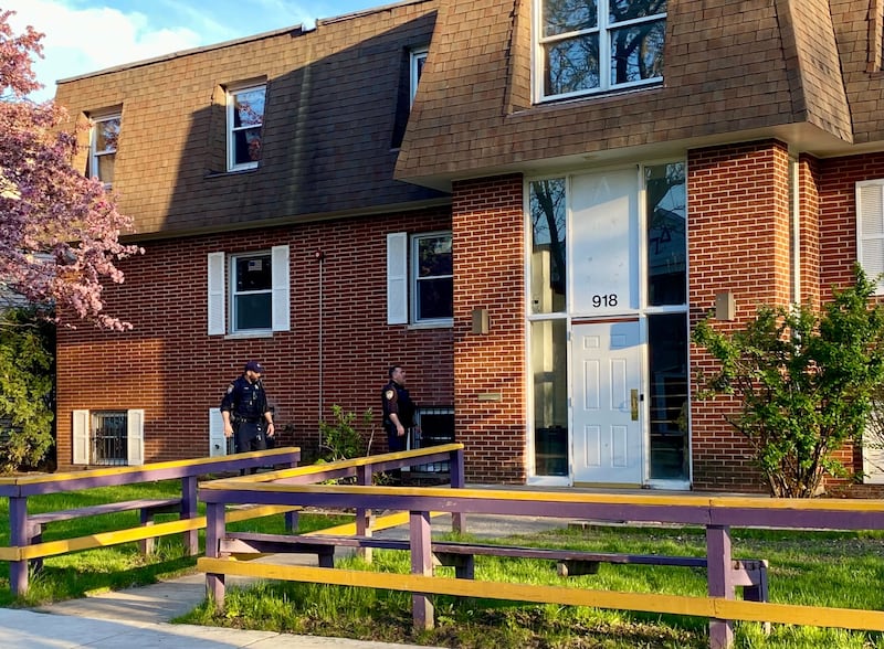 DeKalb police officers appear to search the ground for something on Monday evening, May 5, 2025, in an area outside an apartment building in the 900 block of Kimberly Drive, DeKalb. Police alerted the public to an ongoing investigation of possible gunfire in the area.
