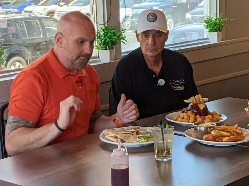 Christina’s Grill & Gatherings owner Allen Soboj, right, talks to Sean Kelly, left, host of America's Best Restaurants, about some of the entrees. America's Best Restaurants was filming an episode for its show on April 21, 2026.