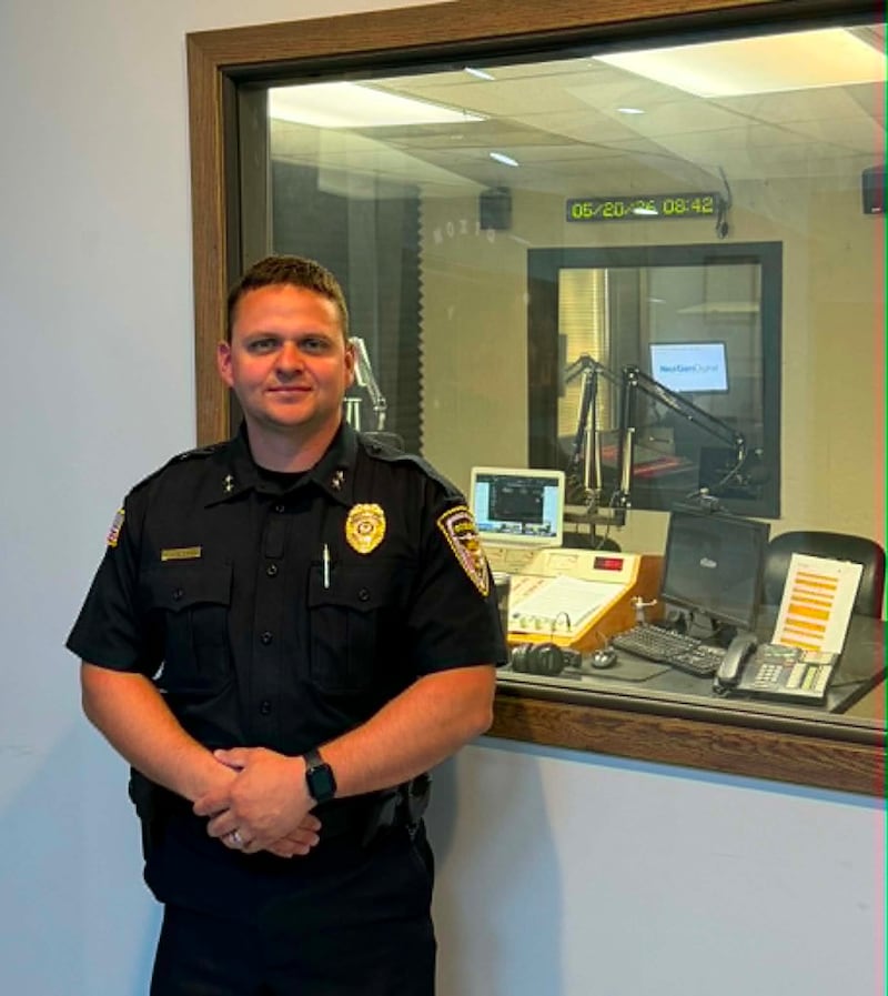 Dixon's Deputy Chief of Police Chris Scott poses for a picture at the WIXN radio station in Dixon on May 20, after appearing as a guest on Talk Line.