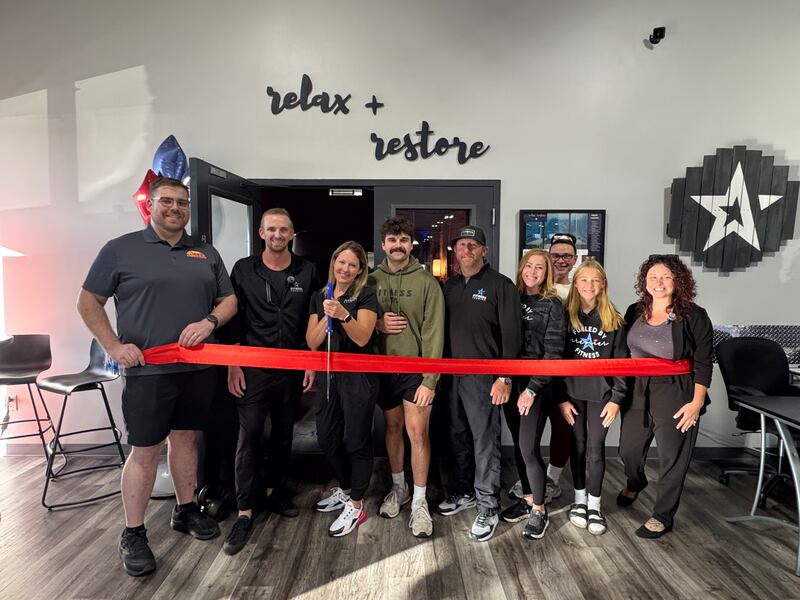 The Channahon Minooka/Grundy County Chamber held a ribbon cutting with Fitness Premier in Minooka to celebrate its new Relax + Restore room. Minooka Trustee Josh Stell, the Fitness Premier team, and Chamber President & CEO Christina Van Yperen pose in front of the new suite before the official cutting.