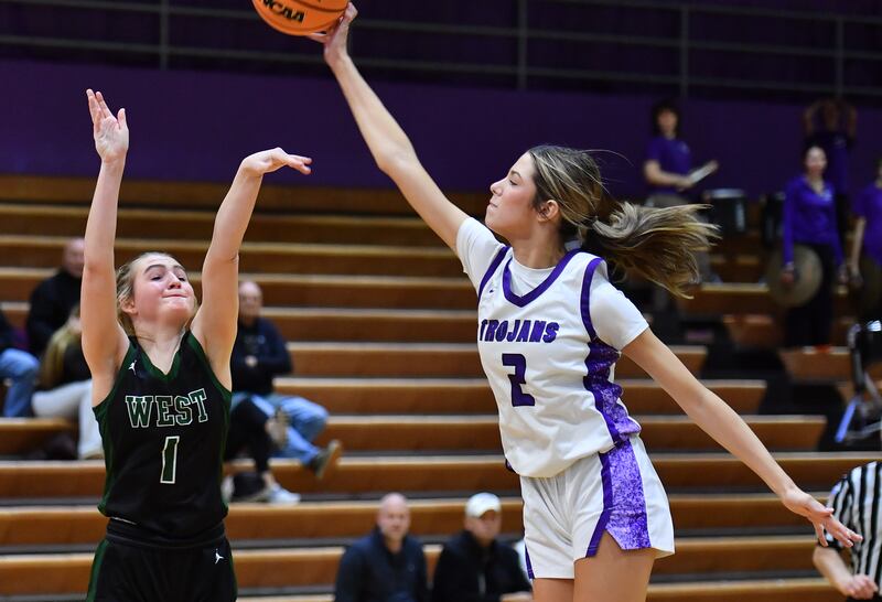 Downers Grove North’s Eva Yerkovich blocks a last ditch three point shot by Glenbard West’s Nina Hendricksen (1) to seal the win for the Trojans on January 17, 2026 at Downers Grove North High School in Downers Grove .