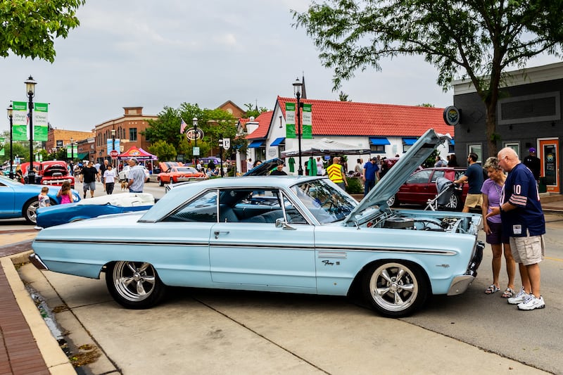 Attendees enjoy checking out the classic cars on Lockport Street during the first Plainfield Cruise Night of the season on June 3, 2025.