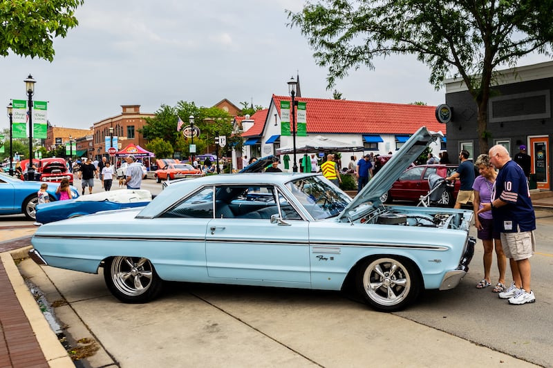 Attendees enjoy checking out the classic cars on Lockport Street during the first Plainfield Cruise Night of the season on June 3, 2025.