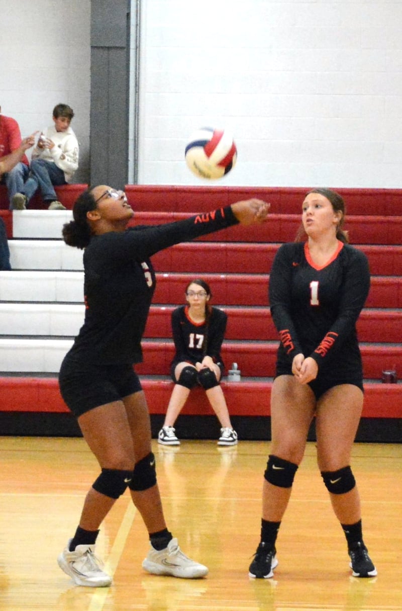 LaMoille's Olivia Glasper and Grace Kelly make a play on the ball in Tuesday's match against Henry-Senacwhine at Dean Madsen in LaMoille.