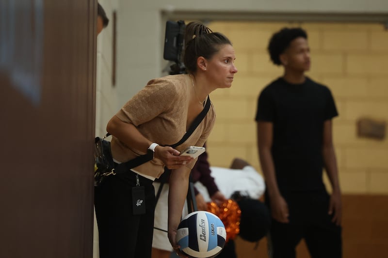 Minooka Athletic Director Emily Brown, who played for Joliet Catholic when the Angels won their first State champion, throw the ball back during the match at Joliet Catholic on Wednesday, Aug. 30, 2023 in Joliet.