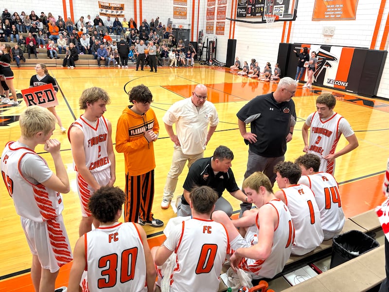 Flanagan-Cornell boys basketball coach Brian Yoder (at center) talks things over with his Falcons during a third-quarter timeout Friday, Jan. 30, 2026, in Flanagan.