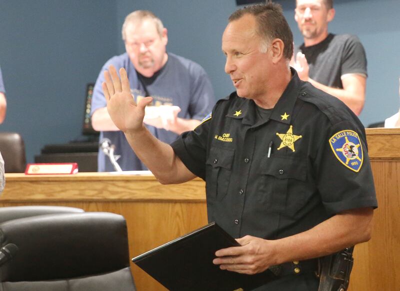 La Salle Police Chief Mike Smudzinski waves farewell to the City council during the La Salle City Council meeting on Monday, Sept. 29, 2025. Smudzinski has been with the La Salle Police Department for 28 years and became Police Chief in 2020. Smudzinski officially retires on Oct. 10, 2025.