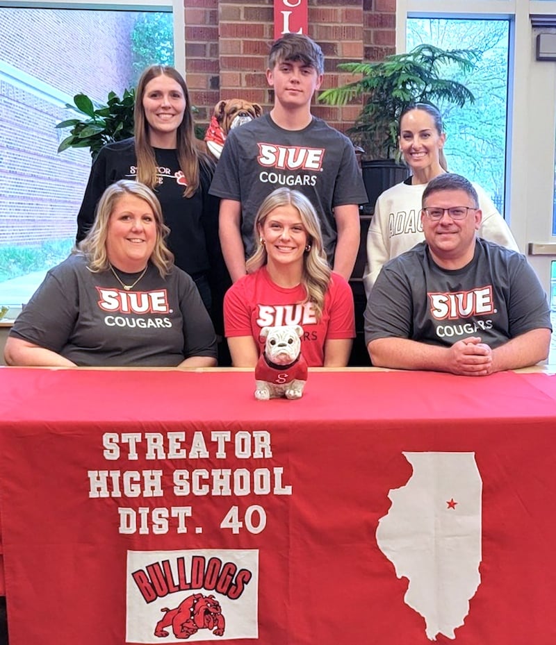 Recent Streator graduate Emma Devera – seated at center here between parents Megan and Jeremy Devera – has committed to continue her education at Southern Illinois University Edwardsville and her dance career at the National Dance Alliance Division I level with the SIUE Dance Team. Standing behind at her signing ceremony are dance coaches Ashley Manypenny (left) and Rachel Martin (right) along with Emma's brother, Eddie Devera.