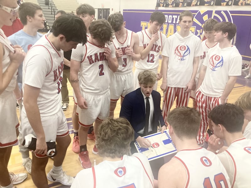 Oregon coach Jarrett Reynolds draws up a play during Tuesday's sectional semifinal game at Mendota. The Hawks saw their season come to a close with a 69-67 loss to Rockford Lutheran in overtime.