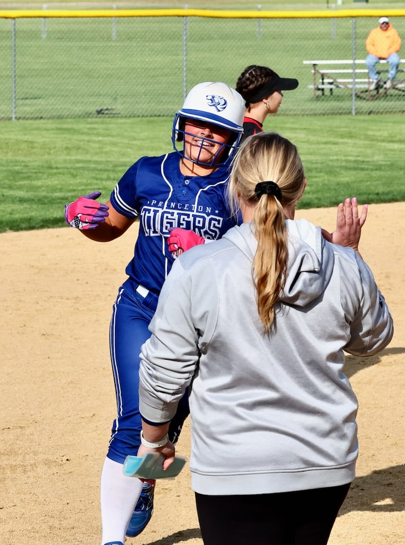 Princeton's Avah Oertel high fives coach Jessica Strauch after hitting a home run during the Tigresses' 15-0, four-inning victory on Thursday, May 7, 2026 in Princeton.