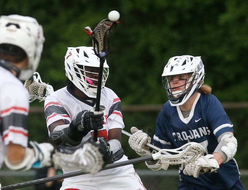 Huntley's S.J. Engmann takes a shot at the goal as Cary-Grove's Ostin Hansen defends during the Marian Central Sectional boys lacrosse semifinal match on Wednesday, May 28, 2025, at Marian Central High School in Woodstock.