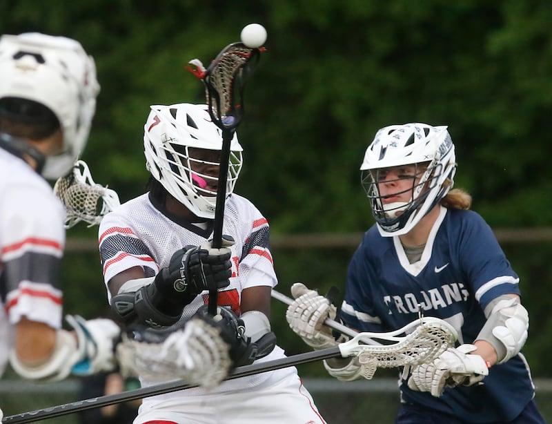 Huntley's S.J. Engmann takes a shot at the goal as Cary-Grove's Ostin Hansen defends during the Marian Central Sectional boys lacrosse semifinal match on Wednesday, May 28, 2025, at Marian Central High School in Woodstock.