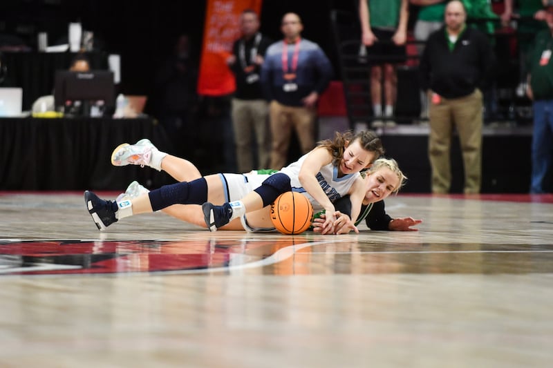 CIssna Park's Julia Edelman dives for a loose ball against Carrollton's Abby Flowers during the Timberwolves' 55-39 loss to Carrollton in the IHSA Class 1A State semifinal on Thursday, March 6, 2025. Cissna Park advances to the third place game on Friday, March 7.