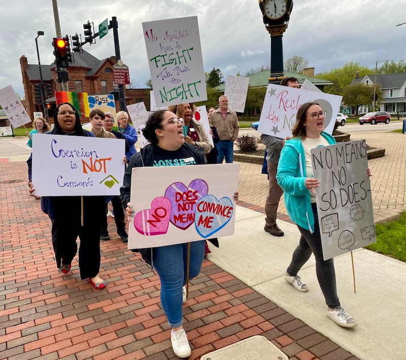 Event-goers at Safe Passage's annual Take Back the Night chant together in downtown DeKalb on Monday, April 27, 2026. They carried signs to advocate against sexual violence and to mark Sexual Violence Awareness Month, in its 25th year.