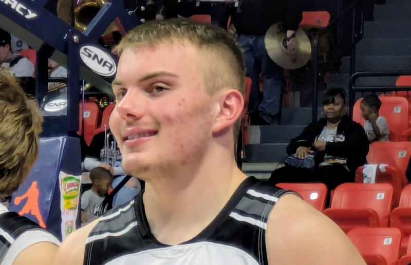 Kaneland senior Marshawn Cocroft holds the Class 3A third-place trophy at the State Farm Center on March 13, 2026, in Champaign.