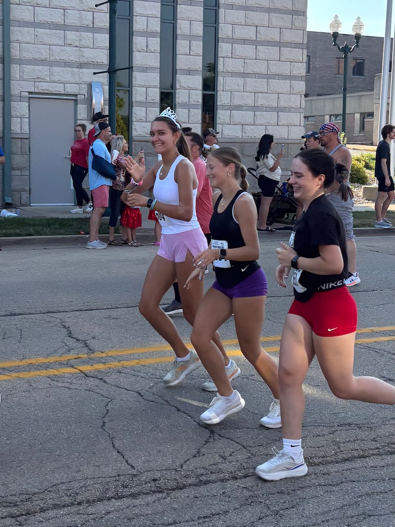 Dani Lovett (far left) runs with friends during the 2025 Reagan Run, as Petunia Queen.