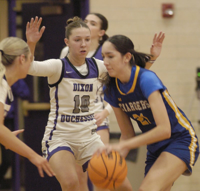 Dixon's Addy Lohse applies defensive pressure against Aurora Central Catholic's Sofia Orozco. The Dixon Duchesses played the Aurora Central Catholic Chargers in the Dixon Holiday Tournament
at Dixon High School on Friday, December 26th, 2025