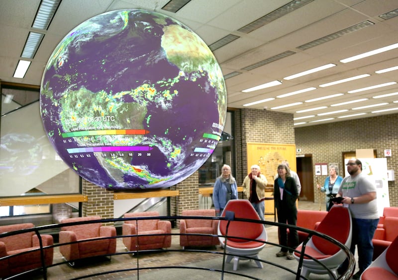 Attendees stop by the science on the sphere exhibit Saturday, April 5, 2025, during Earth Fest in Founders Memorial Library at Northern Illinois University in DeKalb.