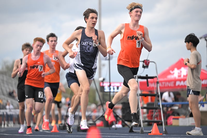 Wheaton Warrenville South’s Liam Meyer leads the boys 3,200-meter run half way through at the Naperville North Gus Scott boys and girls track and field invitational on Friday, Apr. 17, 2026 in Naperville. In second place on this lap is eventual winner Jameson Temopir of Cary-Grove.