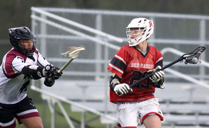 Huntley’s Bobby Pupich, right, moves the ball in varsity boys lacrosse at Prairie Ridge  High School in Crystal Lake on Thursday, May 1, 2025.