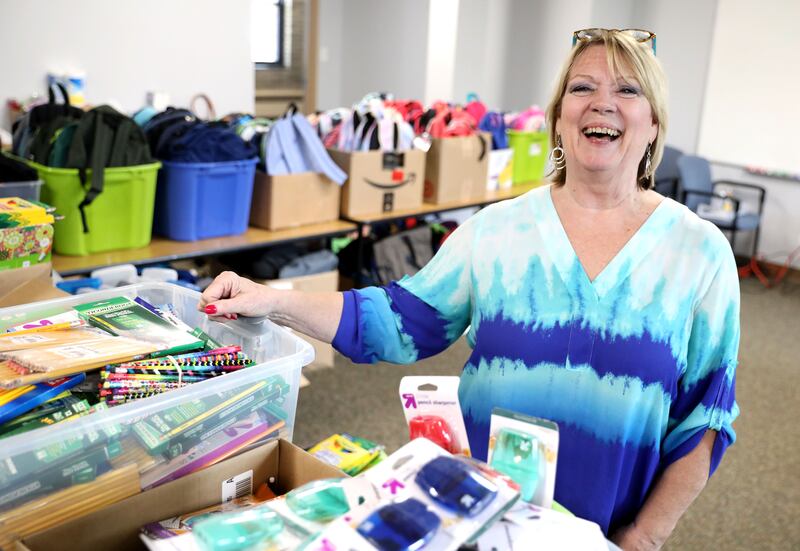 Program Director Kathy Nazzarini of Hope’s Front Door stands among boxes and boxes of donated backpacks and school supplies that will be distributed to families at the First Congregational Church of Downers Grove.
