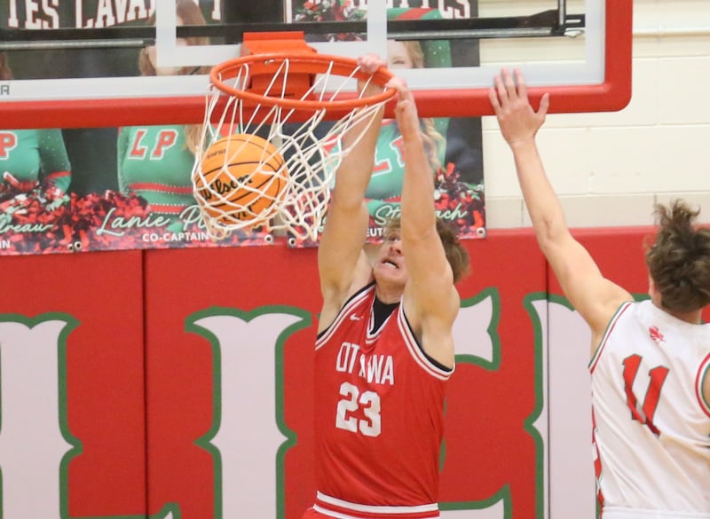 Ottawa's Owen Sanders dunks the ball over L-P's Jameson Hill during the Class 3A Regional title game on Wednesday, Feb. 25, 2026 in Sellett Gymnasium at L-P High School.