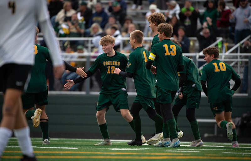 Coal City's Carter Hollis, center left, is congratulated on a goal in the first half of a sectional game against Herscher on Tuesday, October 28, 2025.