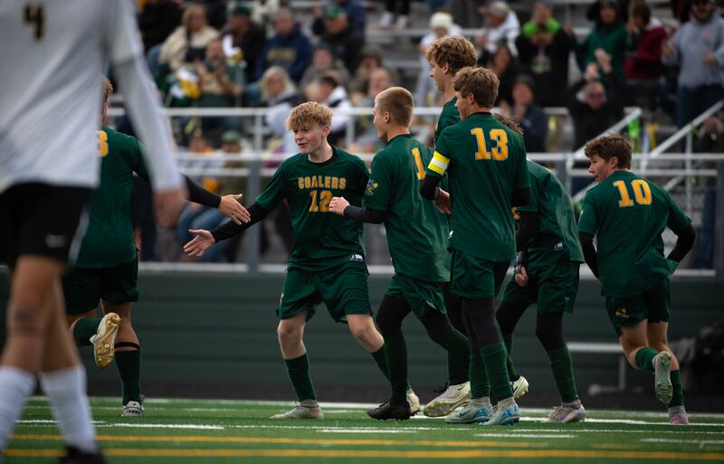 Coal City's Carter Hollis, center left, is congratulated on a goal in the first half of a sectional game against Herscher on Tuesday, October 28, 2025.