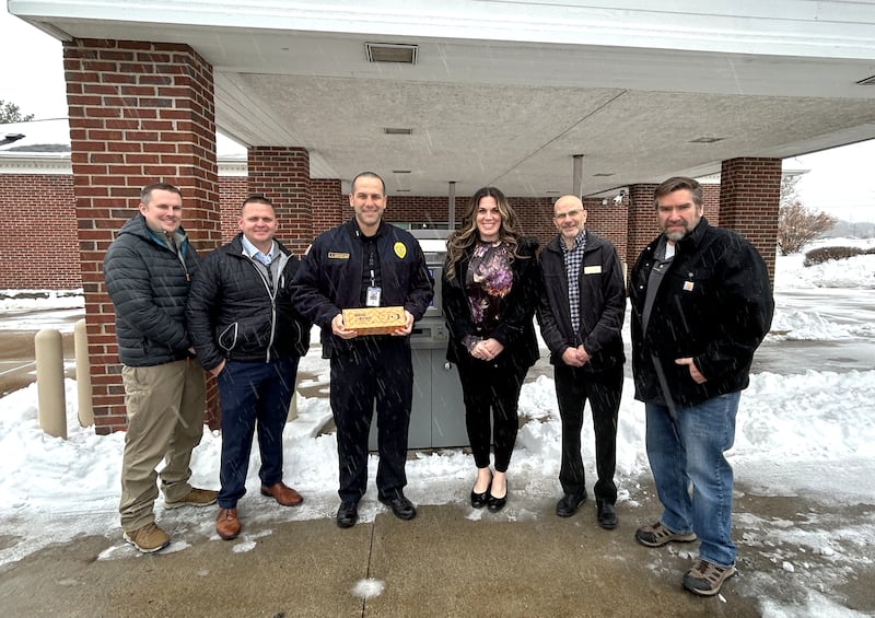 Dixon Police Sgt. Chris Scott (from left), Sgt. Ed Deets and Deputy Chief Aaron Simonton accept two card skimmer detection devices from AVP of Development and Engagement Taylor Boostrom, Universal Banker David Burnett, and Security Officer and Network Administrator Jay Shaw.