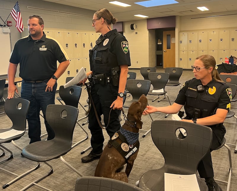 Dooley, a German Shorthaired Pointer, a Sycamore police therapy dog handled by school resource officer Kaitlyn Pederson gets scratches from Pederson's supervisor Sergeant Stacey Binkowski on June 24, 2025. They were at Sycamroe Middle School so that Pederson and fellow school resource officer Daniel Ludwig could present their annual report to the Sycamore board of education.