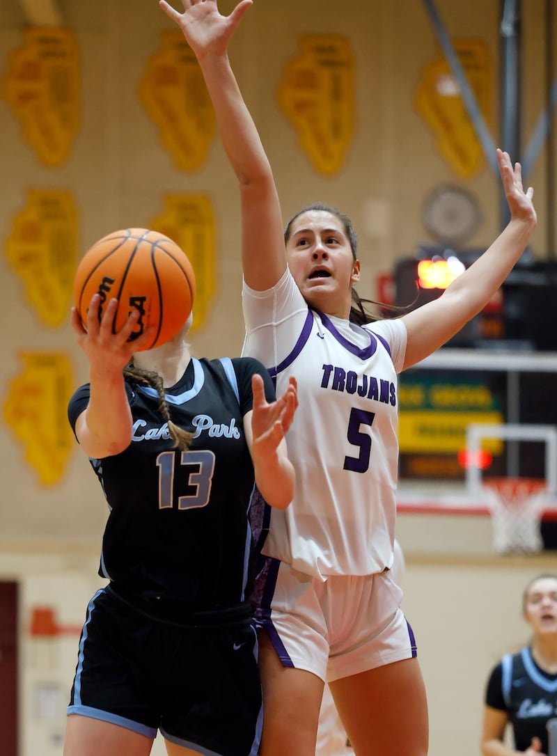 Lake Park's Allison Gogola (13) goes to the hoop as Downers Grove North's Campbell Thulin (5) attempts to block her shot during the Schaumburg High School Lady Saxons Thanksgiving Basketball Tournament Friday, Nov. 28, 2025 in Schaumburg.
