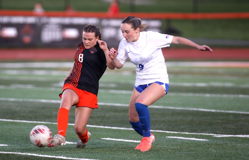 St. Charles East's Georgia Smith and St. Charles North’s Addyson Priess go after the ball during a Tri-Cities Soccer Night game on Tuesday, April 29, 2025 in St. Charles.