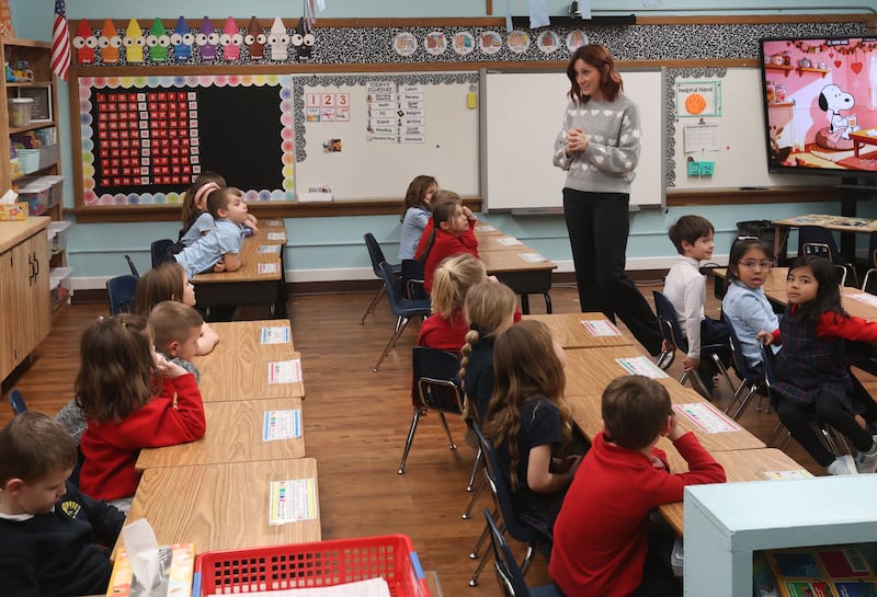Mrs. Katie Henkel, teaches her kindergarten class on Thursday, Feb. 5, 2026 at Holy Cross Elementary School in Mendota. Henkel recently did a "name that kindergartener trend throught the school's Facebook page. It has generated over 22,000 views.