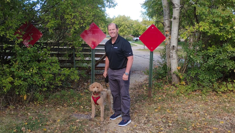 Batavia resident David Carney walks his dog Champ on Skyline Drive, a road that does not go through. Batavia won two court battles to annex the 200-or so feet of right-of-way so it could become connected, officials are not pursuing it at the moment. Carney, among other nearby residents, do not want the road going through, citing safety.