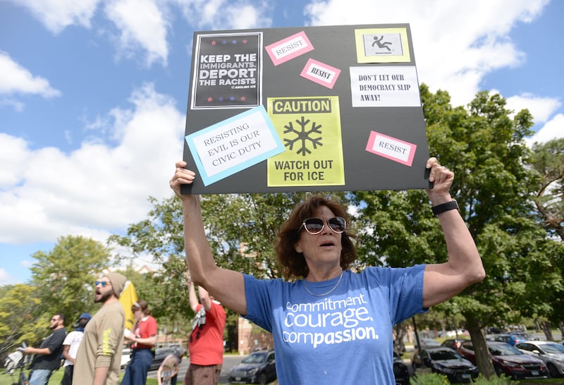 People including Patty Janicek of Downers Grove attend the rally against ICE  outside the Hampton Inn  in Downers Grove Sunday Sept 7, 2025.