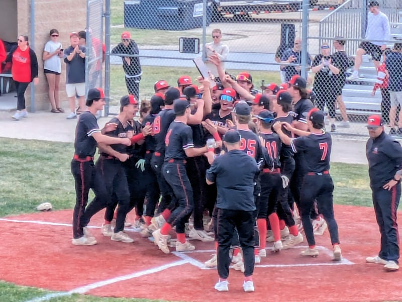 The Huntley baseball team celebrates with the championship trophy after its 4-1 win against DeKalb in the Class 4A DeKalb Regional championship game on Saturday, May 30, 2026 at Dave Pettengel Field in DeKalb.