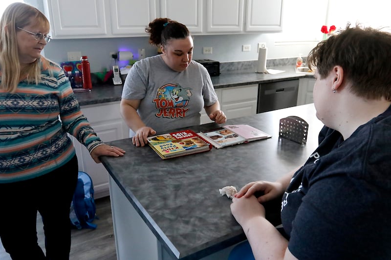 Brittany Woods, (center) talks with Sammi Huffman, (right) and Sammi’s mom, Sandy, about what Woods would like to bake on Tuesday, March 11, 2025. The home is Clearbrook's new community integrated living arrangement home for adults with developmental disabilities in Woodstock.