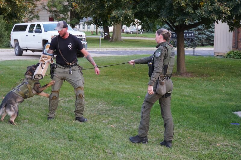 From left to right: Ogle County Sheriff's Office K9 Saint, Deputy Kyle White and Deputy Ali VanVickle put on a demonstration for the Creston Village Board on Sept. 2.